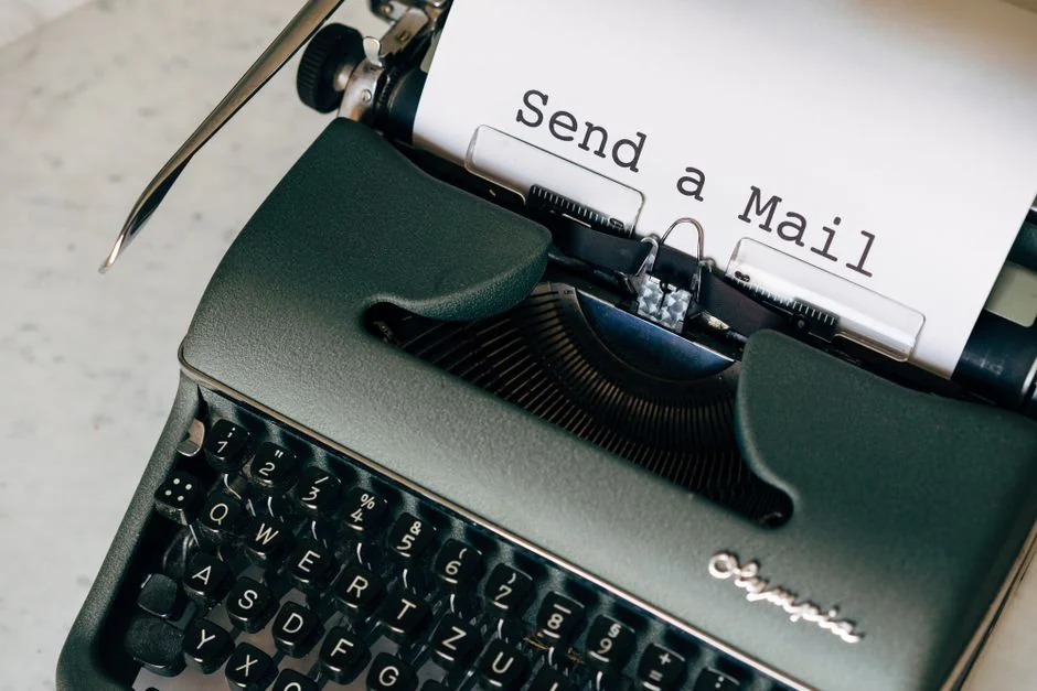 Planner open on a desk with a handwritten note reading Holiday Email Marketing Series.